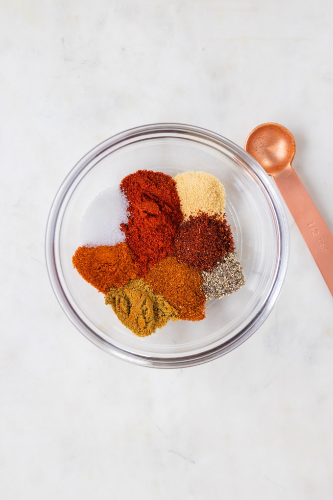 Spices in a glass bowl for blackened salmon recipe