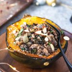 acorn squash on a plate with a fork.