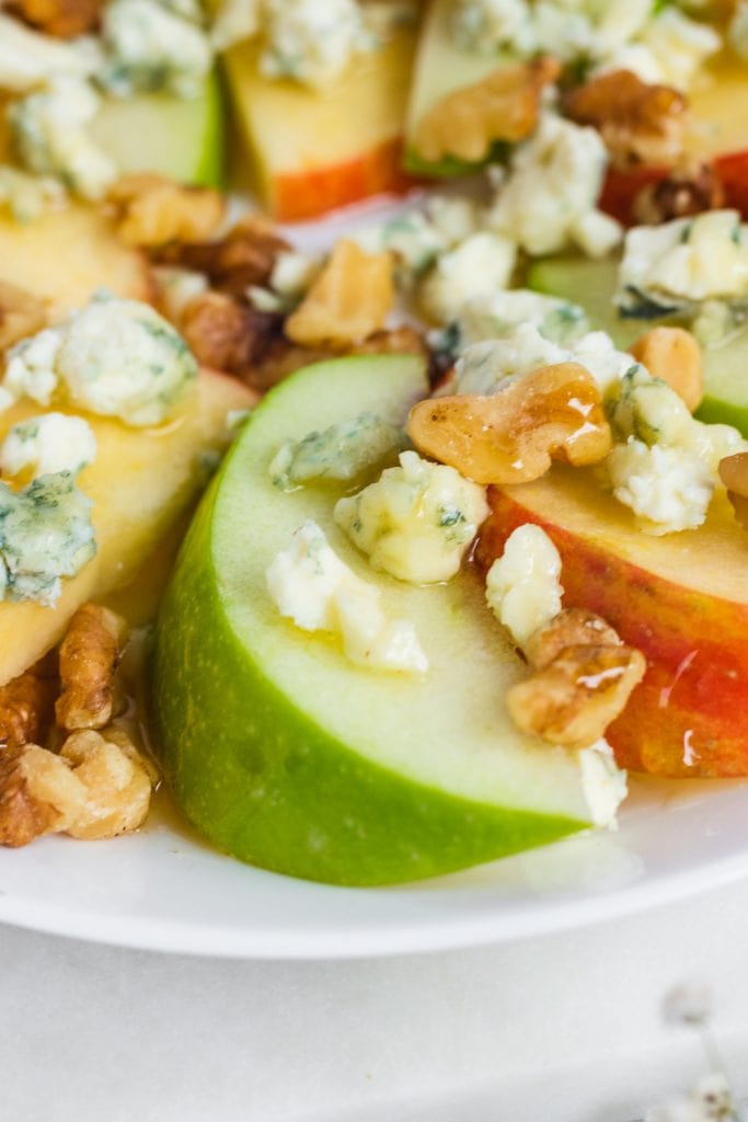 apple slices on a plate with toppings.