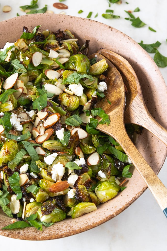 Spoons in a bowl with brussel sprout recipe.