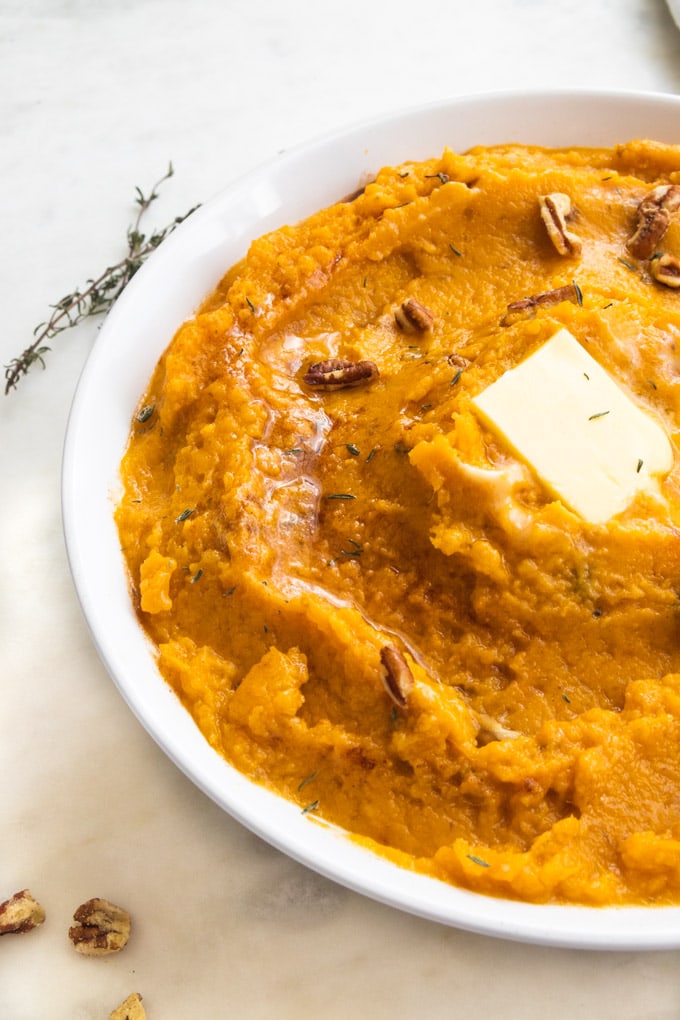 a bowl of mashed sweet potatoes with butter.
