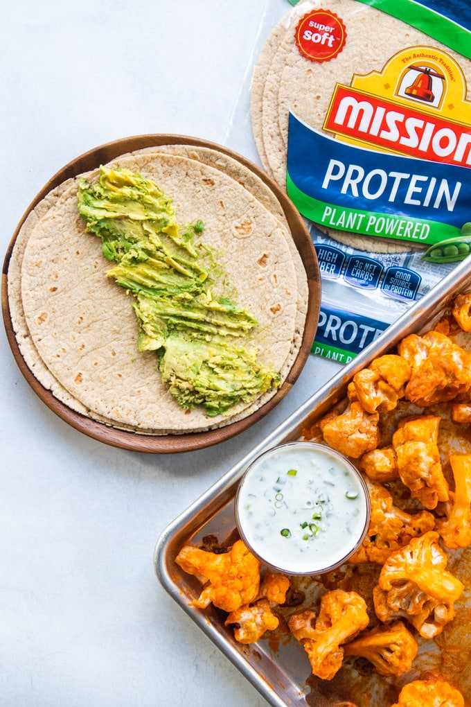 buffalo cauliflower with avocado and sauce.