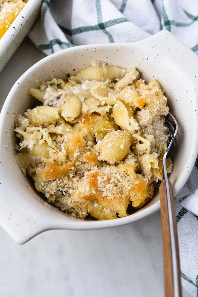 noodles with cheese on them with a fork. 