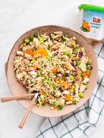 Asian chicken salad with ramen in a bowl with forks.