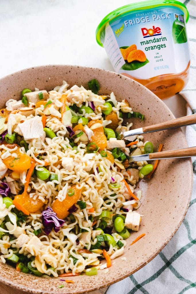 Asian chicken salad in a bowl with oranges and ramen noodles. 