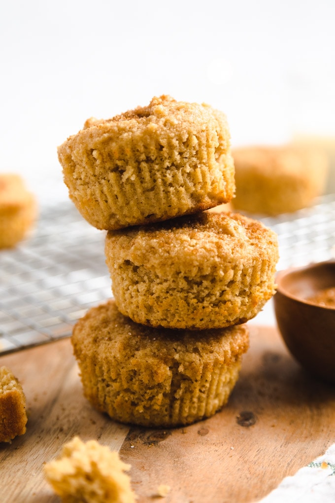 three muffins on top of one another with cinnamon sugar on top.