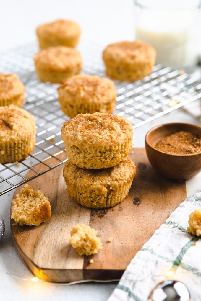 Snickerdoodle muffins with crumbs around them. 