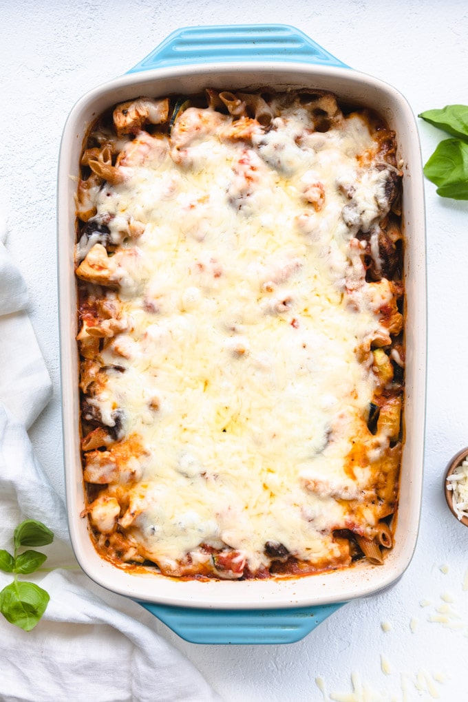 A casserole dish full with cheese on top.