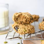 Breakfast cookies on a baking sheet with a glass of milk