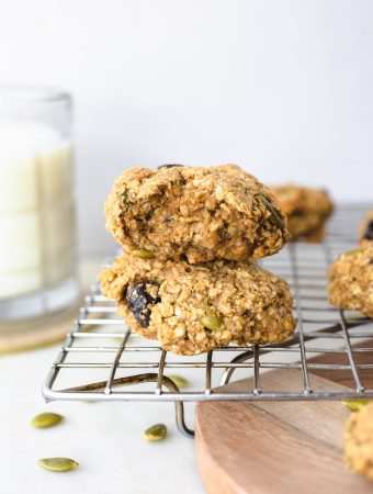 Breakfast cookies on a baking sheet with a glass of milk