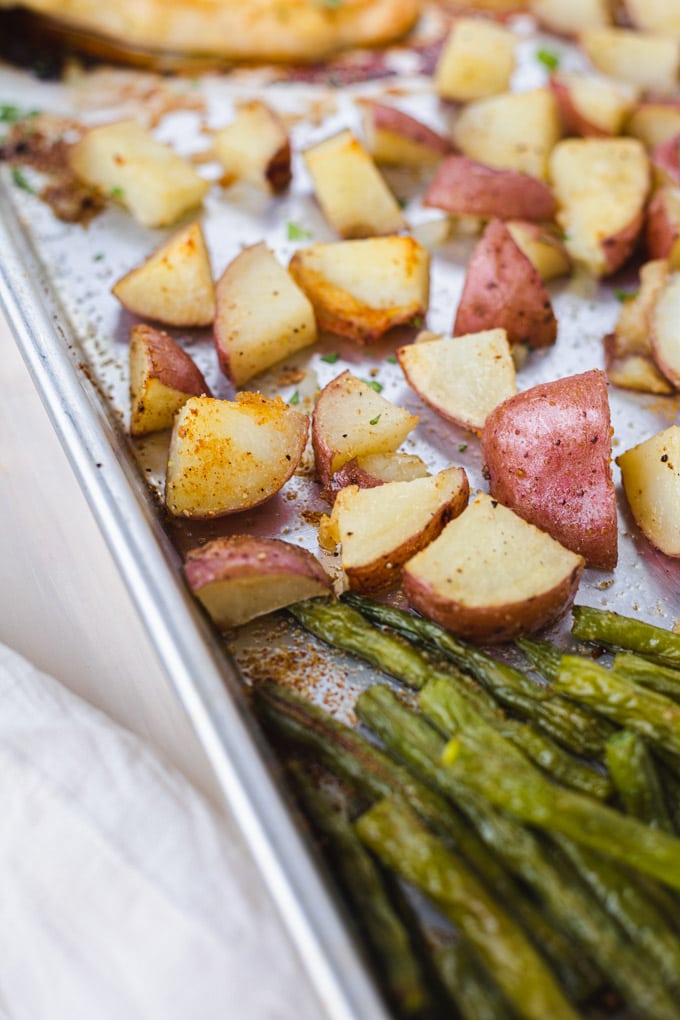 A close up of crispy potatoes on a sheet pan.