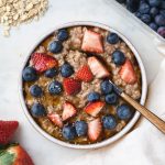 oatmeal with berry topping in a bowl.