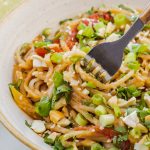 a bowl of noodles with a fork.