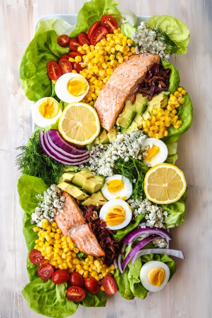 salmon salad on a plate with toppings.