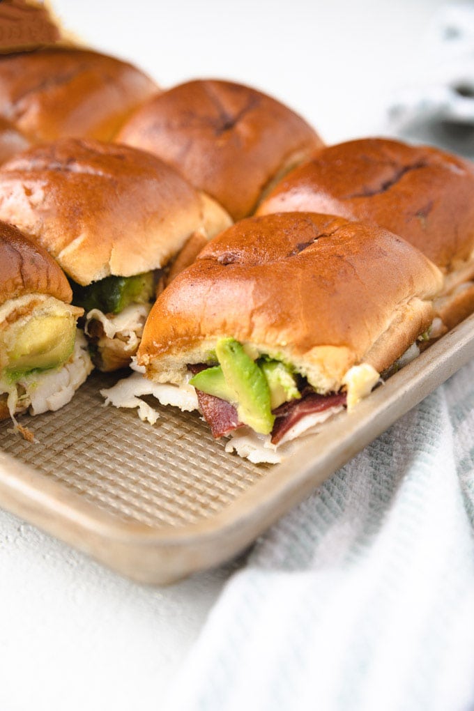 Sheet pan turkey sliders with bacon and avocado.