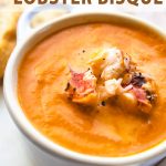 a bowl of easy lobster bisque with text above it.