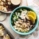 a small bowl filled with healthy ingredients for cauliflower salad.