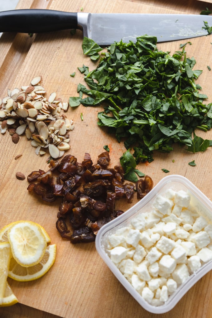 Ingredients for cauliflower salad on a cutting board.