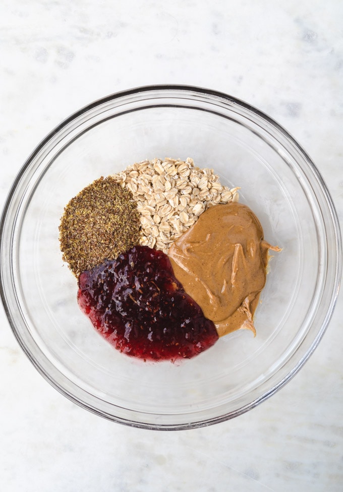 Ingredients for peanut butter and jelly energy balls in a bowl .