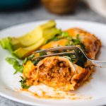 enchilada being cut with fork