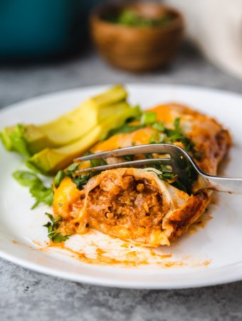 enchilada being cut with fork