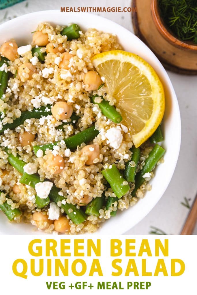 A bowl of green bean quinoa salad with a lemon wedge in it. 