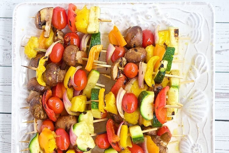 vegetable kabobs on a plate.