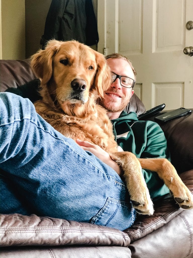 a man with a dog on his lap.