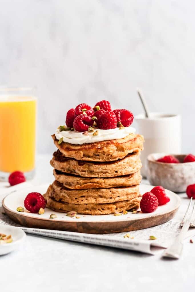 pancakes stacked on top of each other with raspberries.