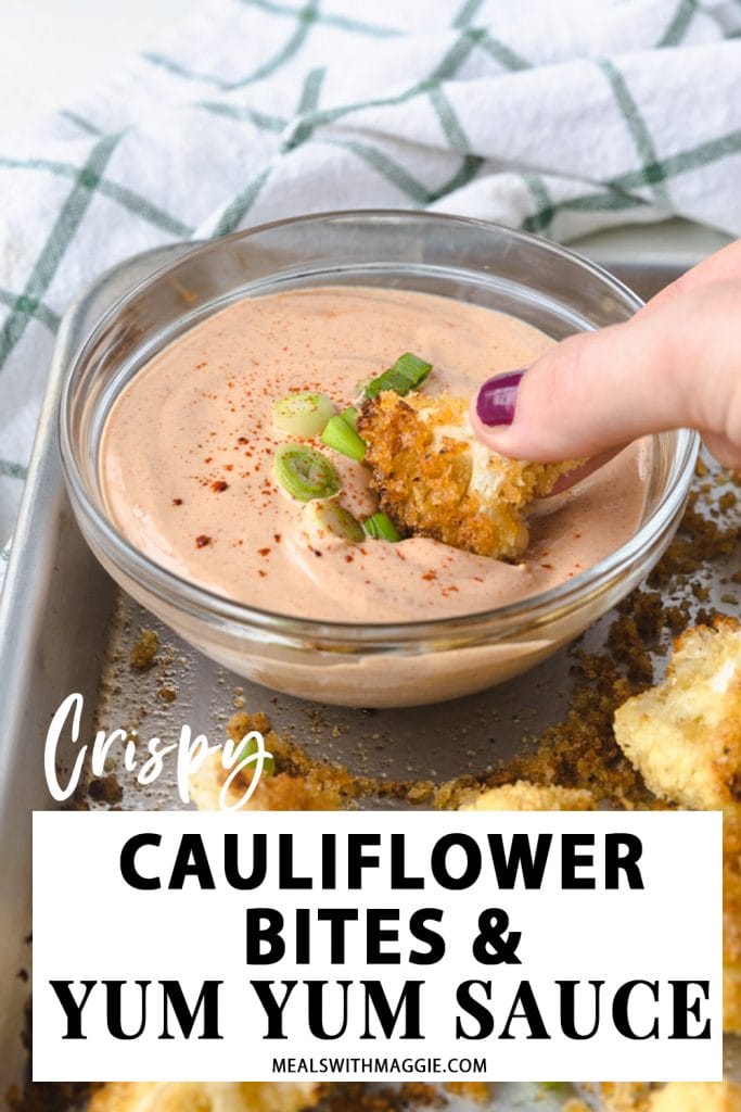 a piece of cauliflower being dipped into sauce.