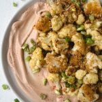 cauliflower bites on a plate with yum yum sauce