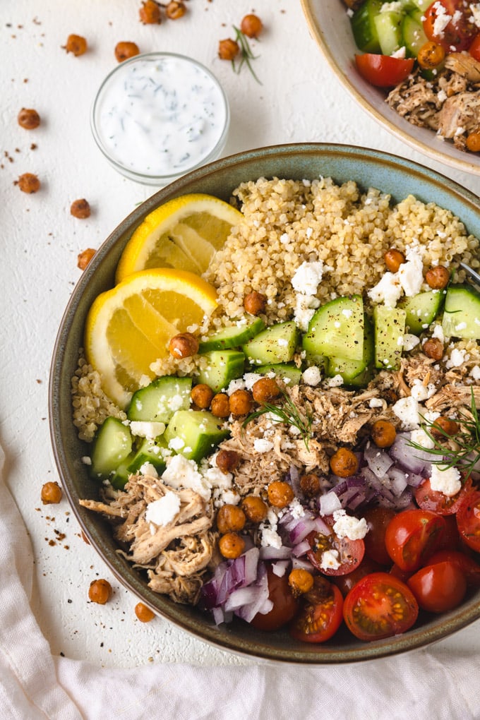 Chicken shawarma bowls with tzatziki sauce on the side. 