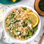 a bowl of green bean salad with lemon in it.