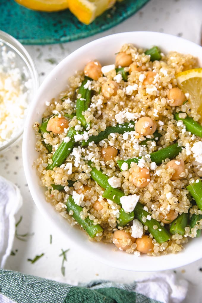 Feta, garbanzo beans and green beans in a bowl. 