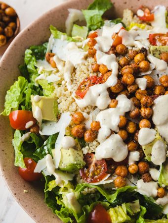 healthy Caesar salad with dressing on top.