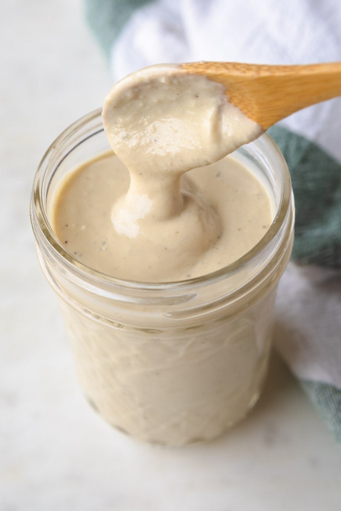 a mason jar full of yogurt dressing. 