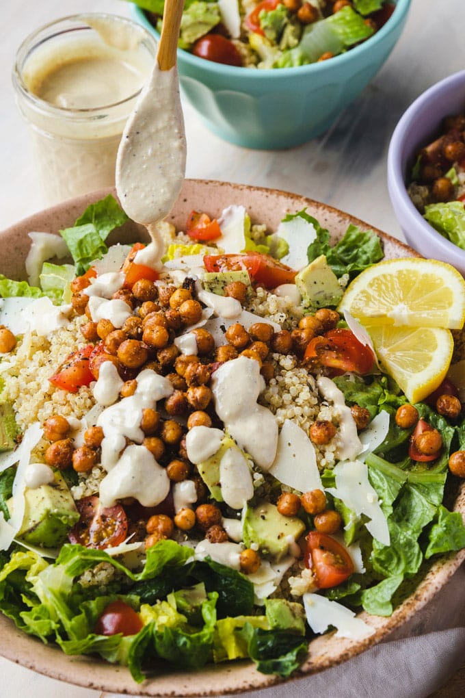 a bowl  with a drizzle of dressing with toppings in the bowl.