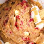 Raspberry lemon cookie batter with a spatula in it.