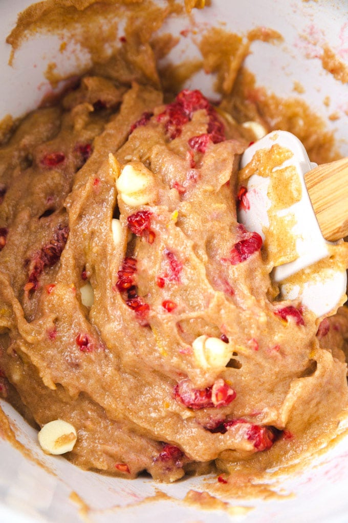 Raspberry lemon cookie batter with a spatula in it.