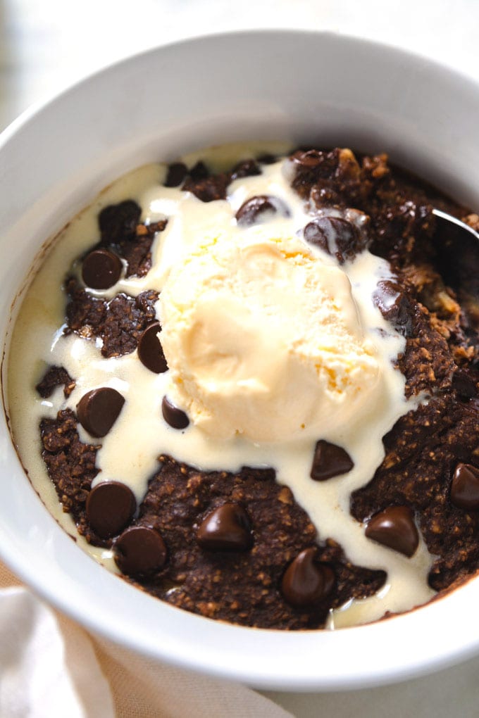 Ice cream on top of brownie bowl.