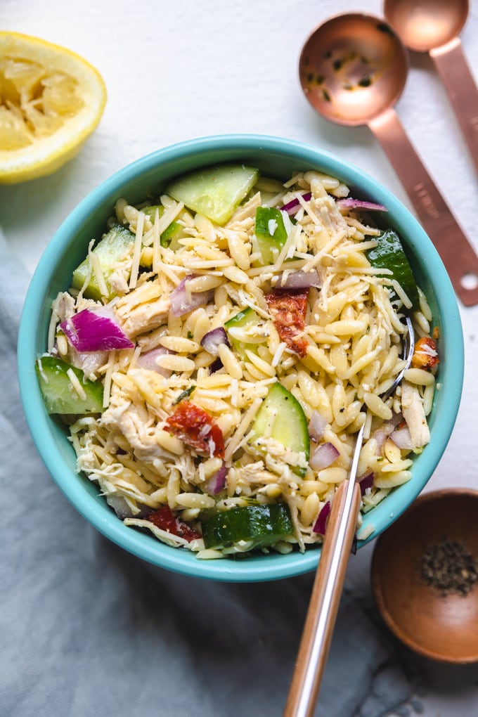 chicken pasta salad in a bowl with a fork in it.