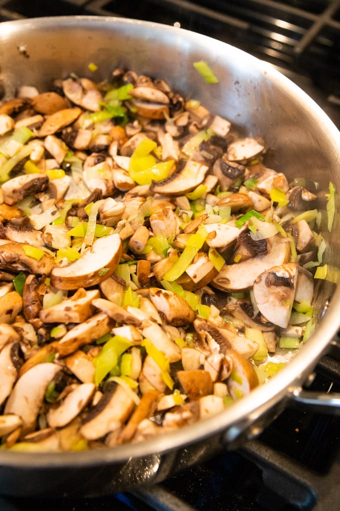 a saucepan of leeks being cooked