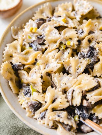 bow tie pasta in a bowl with mushrooms and leeks