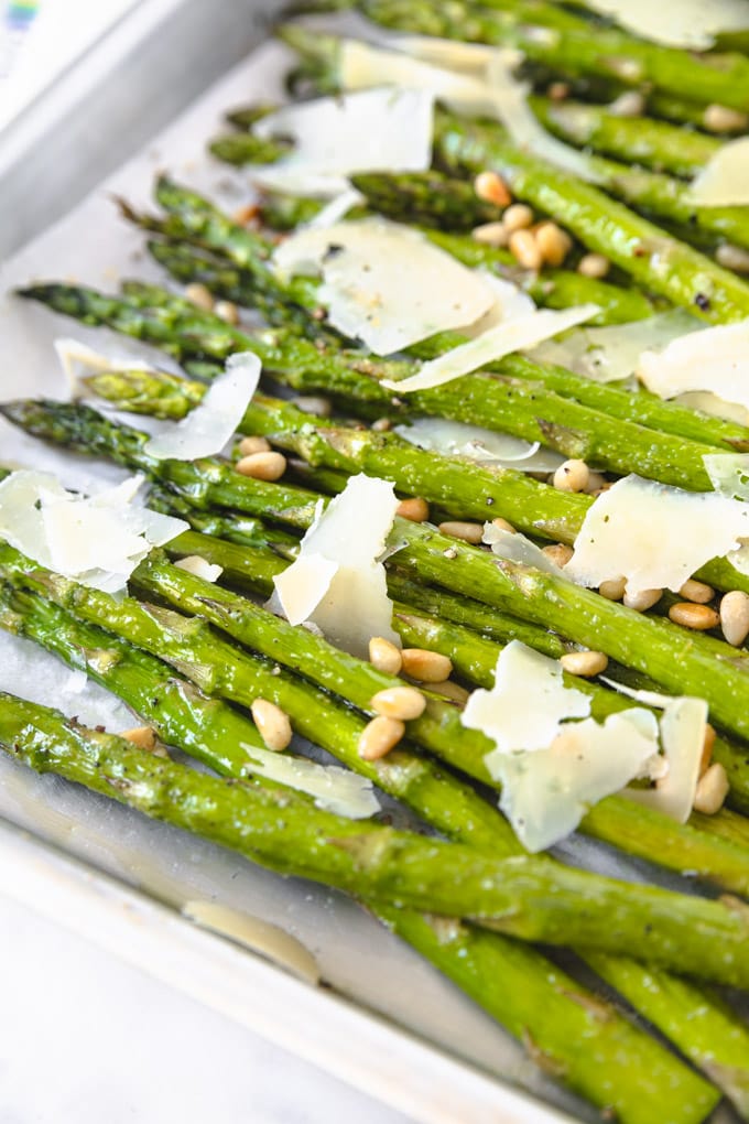 asparagus with pine nuts and parmesan on a serving tray