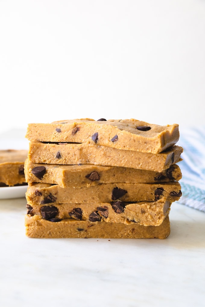 a stack of cookie dough bars on top of one another. 