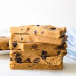 A stack of cookie dough bars with chocolate chips.