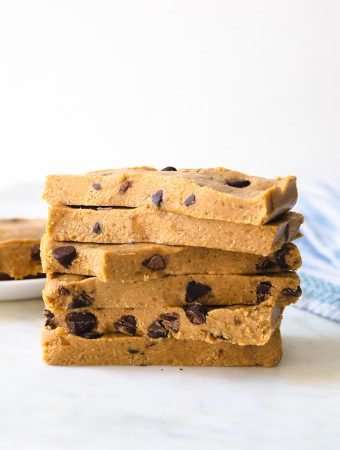 A stack of cookie dough bars with chocolate chips.