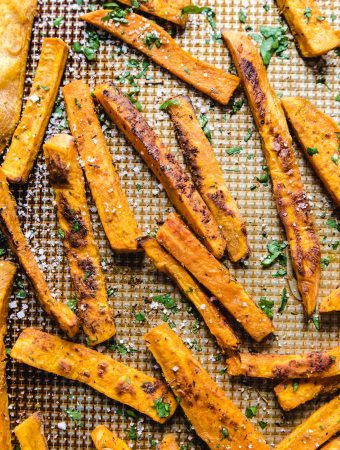 a sheet pan with sweet potato slices on it.