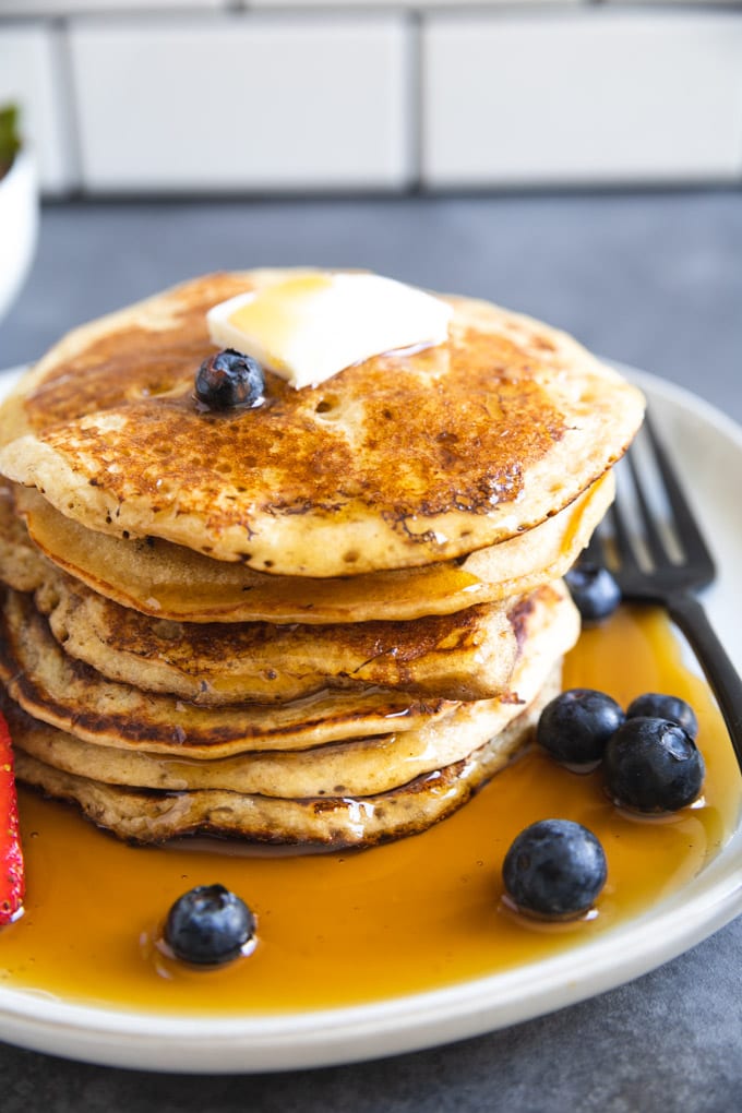 a stack of pancakes with a fork next to it. 