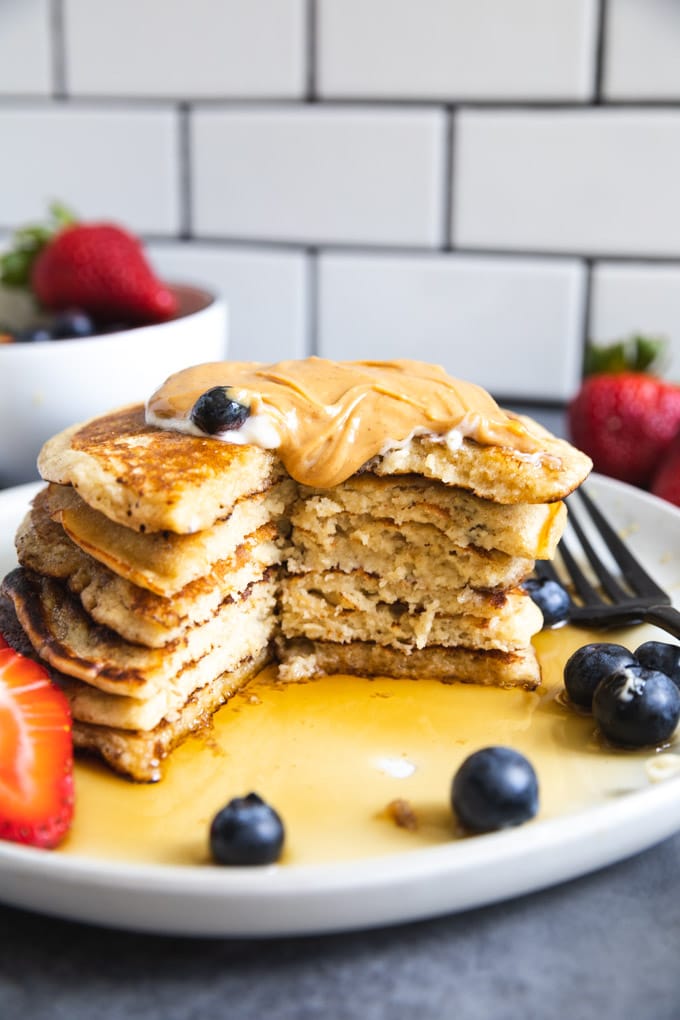 peanut butter and syrup on pancakes with blueberries. 